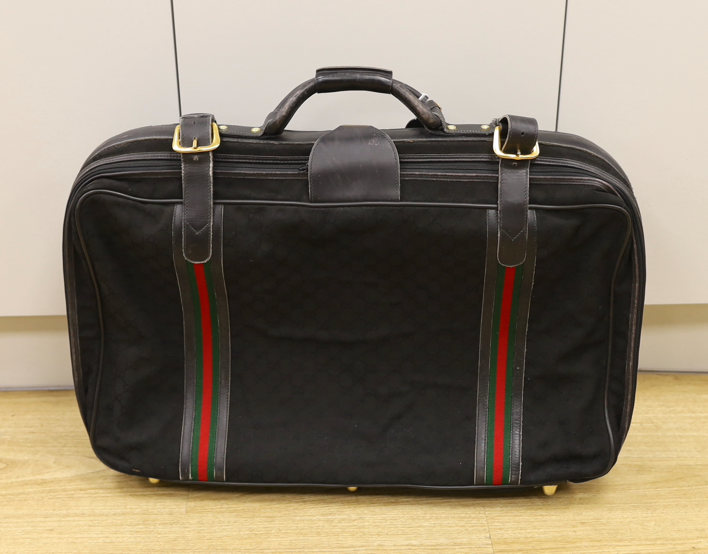 A black fabric and leather trimmed Gucci suitcase